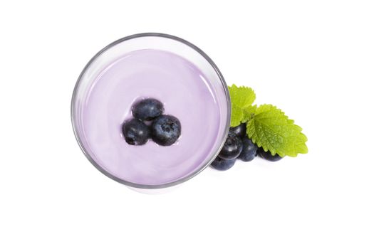 blueberries on top of a blueberry milkshake with blueberries aside