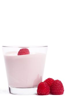 raspberry on a milkshake with raspberries aside