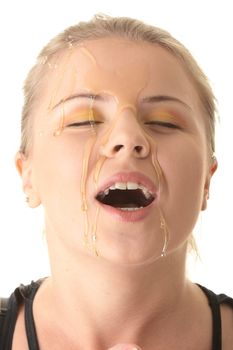 Beautiful young woman with honey on her face