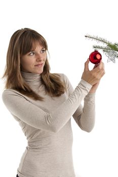 pretty young woman decorating a christmas tree