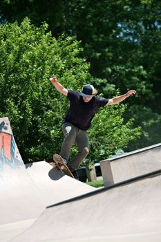 Skateboarder Riding Up a Concrete Skate Ramp
