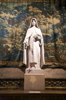 white statue with tapestry