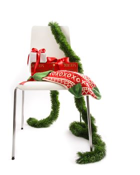White chair with gifts and garland on white 