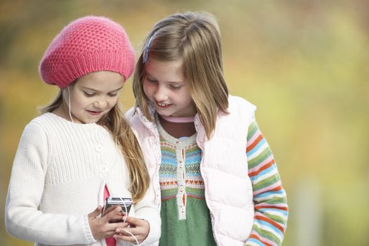 Two Young Girl Outdoors With MP3 Player