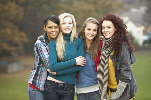 Group Of Four Teenage Girls In Autumn Landscape