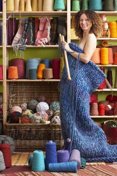 Naked Woman Standing In Knitted Item Standing In Front Of Yarn D