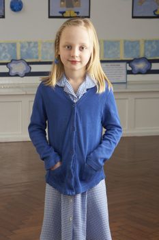 Portrait Of Female Primary School Pupil Standing In Classroom