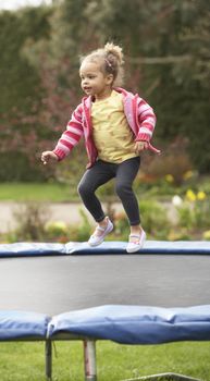 Girl Playing On Trampoline