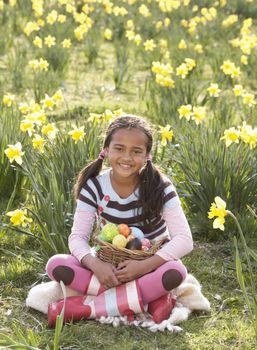 Girl On Easter Egg Hunt In Daffodil Field