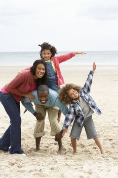 Happy family playing on beach