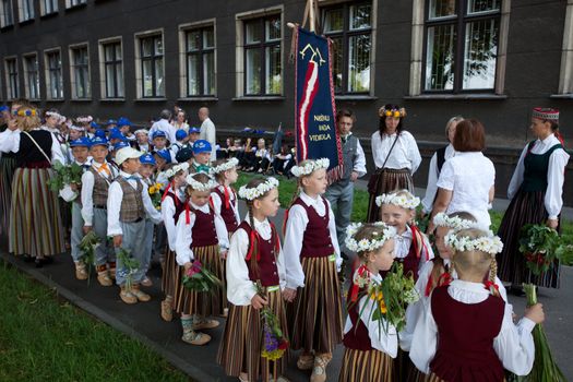 RIGA, LATVIA - JULY 10: A parade by festival participants of Latvian Youth Song and Dance Celebration through the centre of Riga, 10 July, 2010