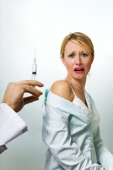 healthcare and medicine: young woman scared of injections