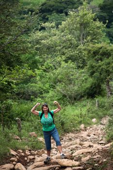 Female hiker flexing on a rugged rustic trail in Costa Rica