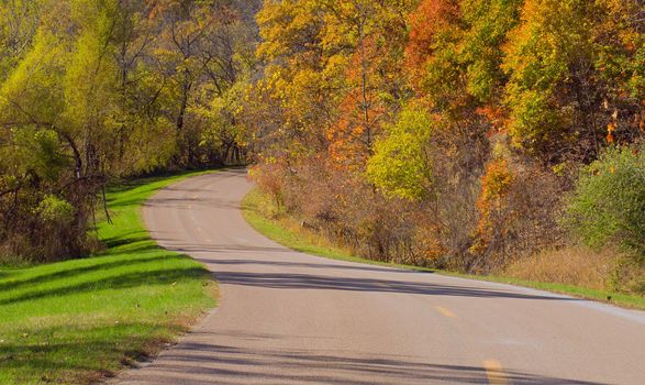 Curving road and autumn woods, Indian Cave State Park, Nebraska, USA
