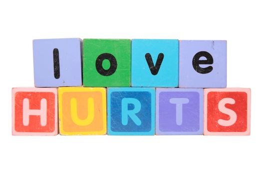 toy letters that spell love hurts against a white background with clipping path