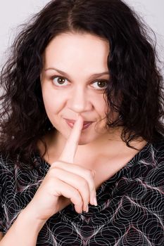 woman with finger on lips