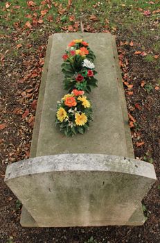 Tombstone covered with flowers