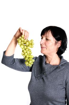 Aged woman with grapes