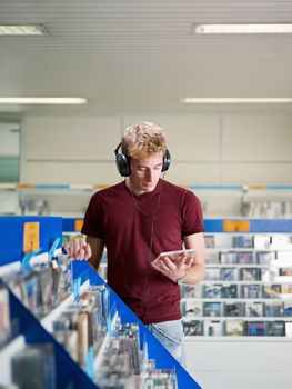 guy listening music in cd store