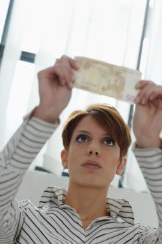 woman checking banknote watermark