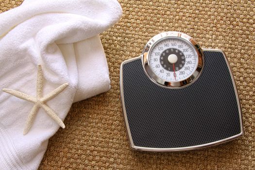 Weight scale with towel on carpet