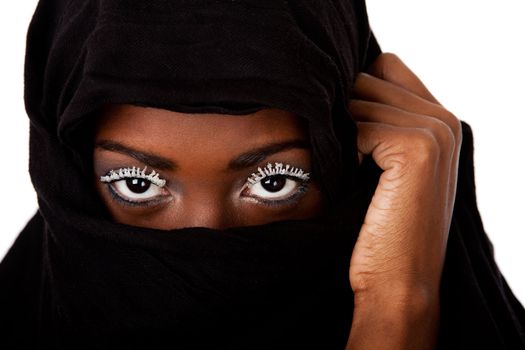 Beautiful female face in black scarf showing eyes with white lashes.