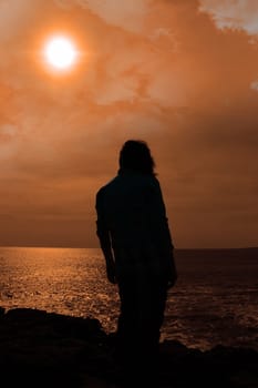 silhouette of a sad lone woman on irish cliff edge