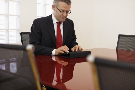 businessman typing on touch pad computer