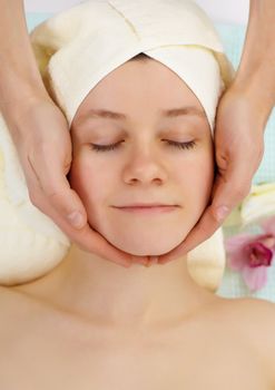 Young girl doing facial in a beauty salon