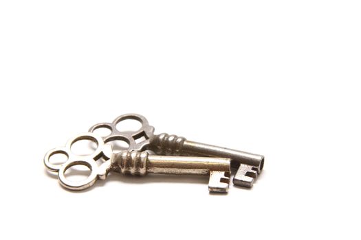 Isolated shot of two metal antique keys on white background