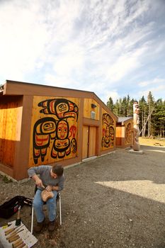 Native carving wood outside native lodge