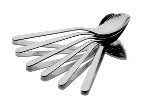 Six spoons spread as a fan on reflecting background