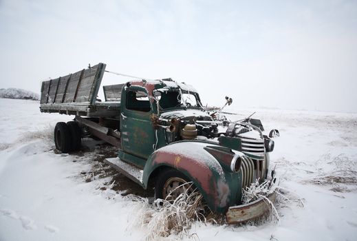 Abandoned old farm truck in winter