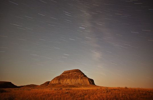 Moon lit Castle Butte and star tracks in scenic Saskatchewan