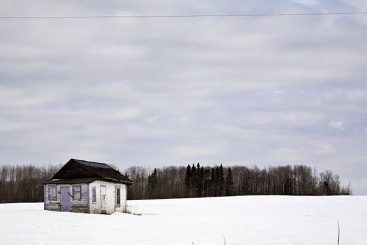 Deserted homestead house in winter