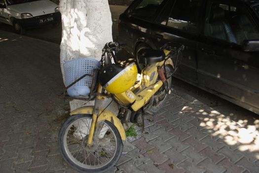Old motorbike with yellow helmet