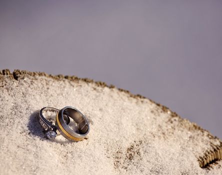 Wedding rings on snow covered mat