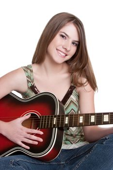 Pretty teenage girl playing guitar