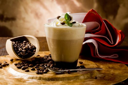 photo of delicious coffee beverage with whipped cream and coffee beans