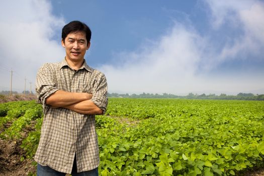 chinese middle aged  farmer and his farm