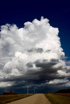 Cumulonimbus storm clouds along a country road