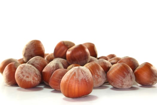 a bunch of hazelnuts on a white background