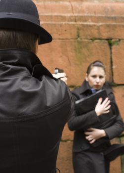 man threatens the woman with gun