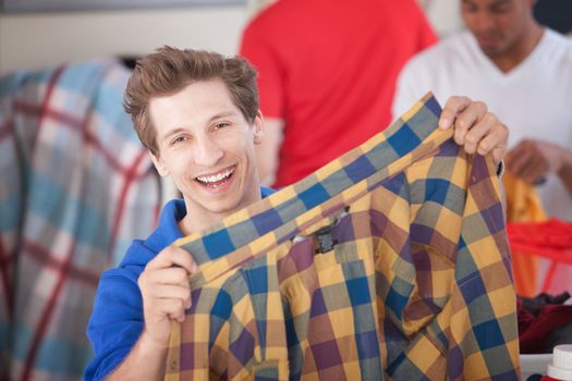 Grinning Man Holding Shirt