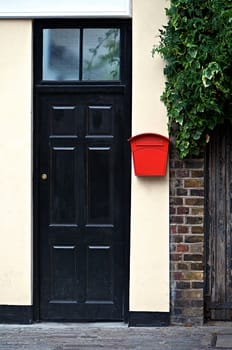 Black door front with red letter box