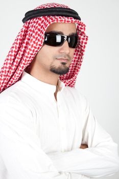 Smiling young success man, arabic traditional clothes wearing sunglasses