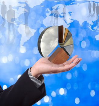 Business man holding pie graph with world map background