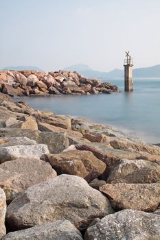 Lighthouse on a Rocky Breakwall: A small lighthouse warns of a r
