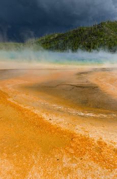 Grand Prismatic Spring and dark storm clouds, Yellowstone National Park, Wyoming, USA