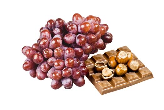 Red grapes with chocolate and nuts in shells on white background